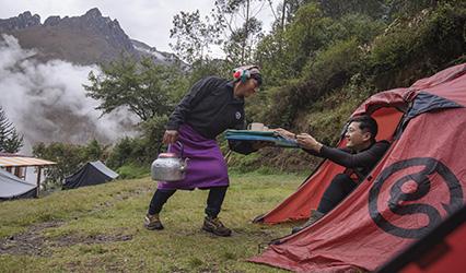Peru Inca Trail Day 2 Camp Tent Male Traveller Server Serving Tea